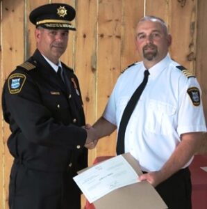 Deputy Chief DaveSmith (Station 1) Presents Chief Medve with his Certificate